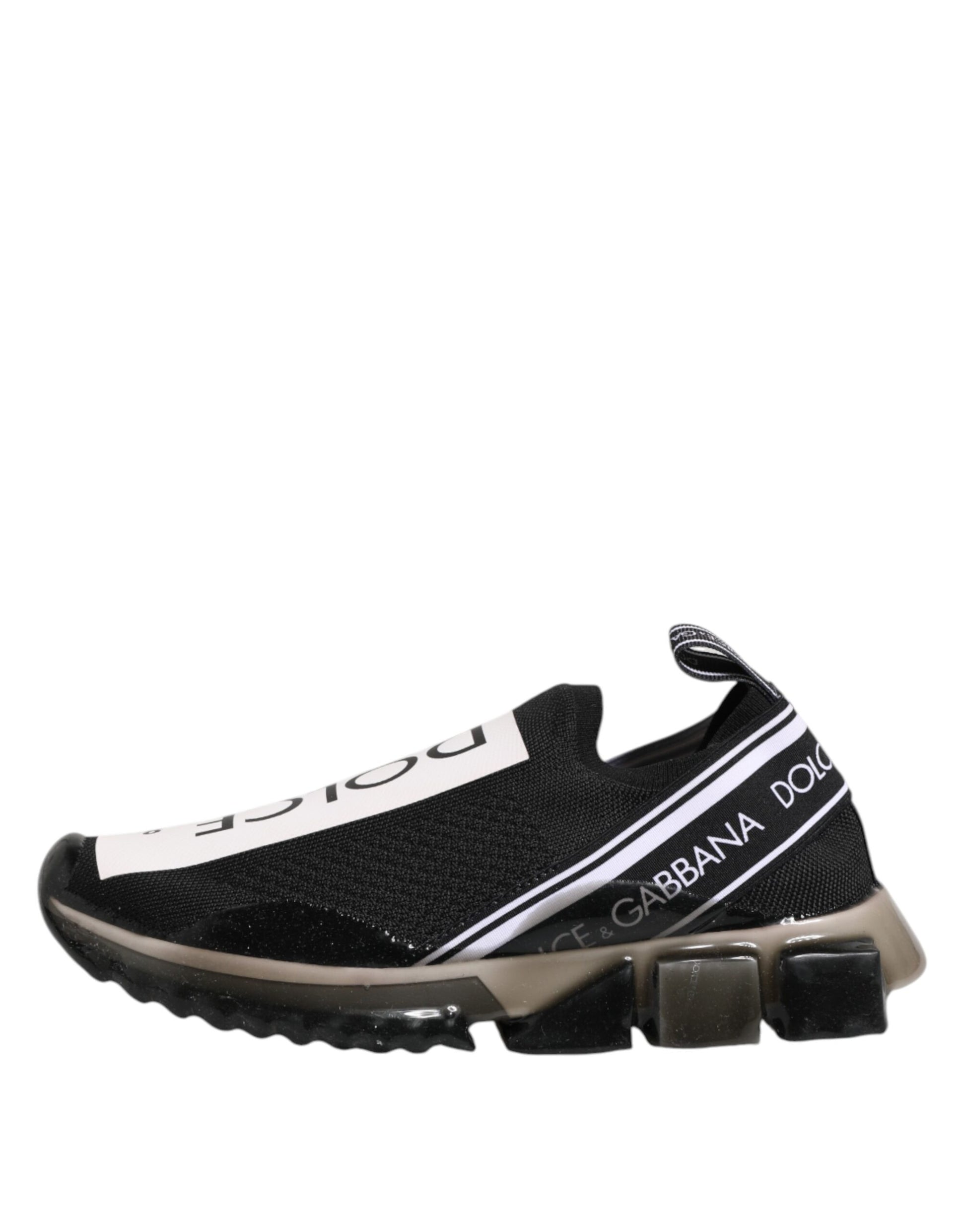 A pair of black slip-on shoes with white and gold accents, featuring the Dolce & Gabbana logo