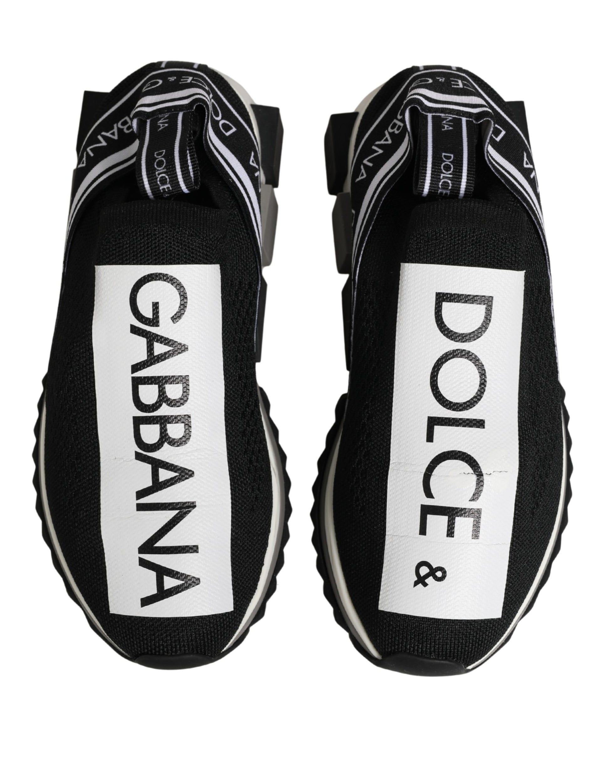 Pair of black slip-on shoes with white text and checkered design