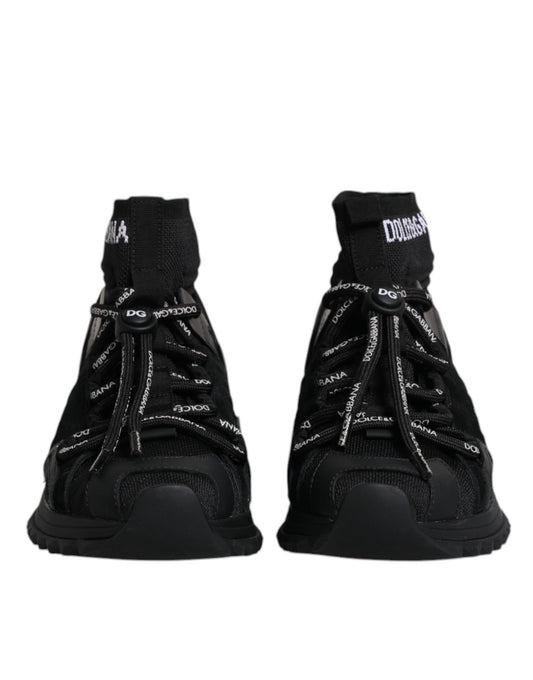 Pair of black sneakers with white laces and brand name on side