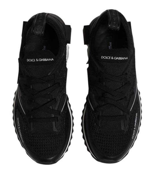 Pair of black athletic shoes with white logo on side