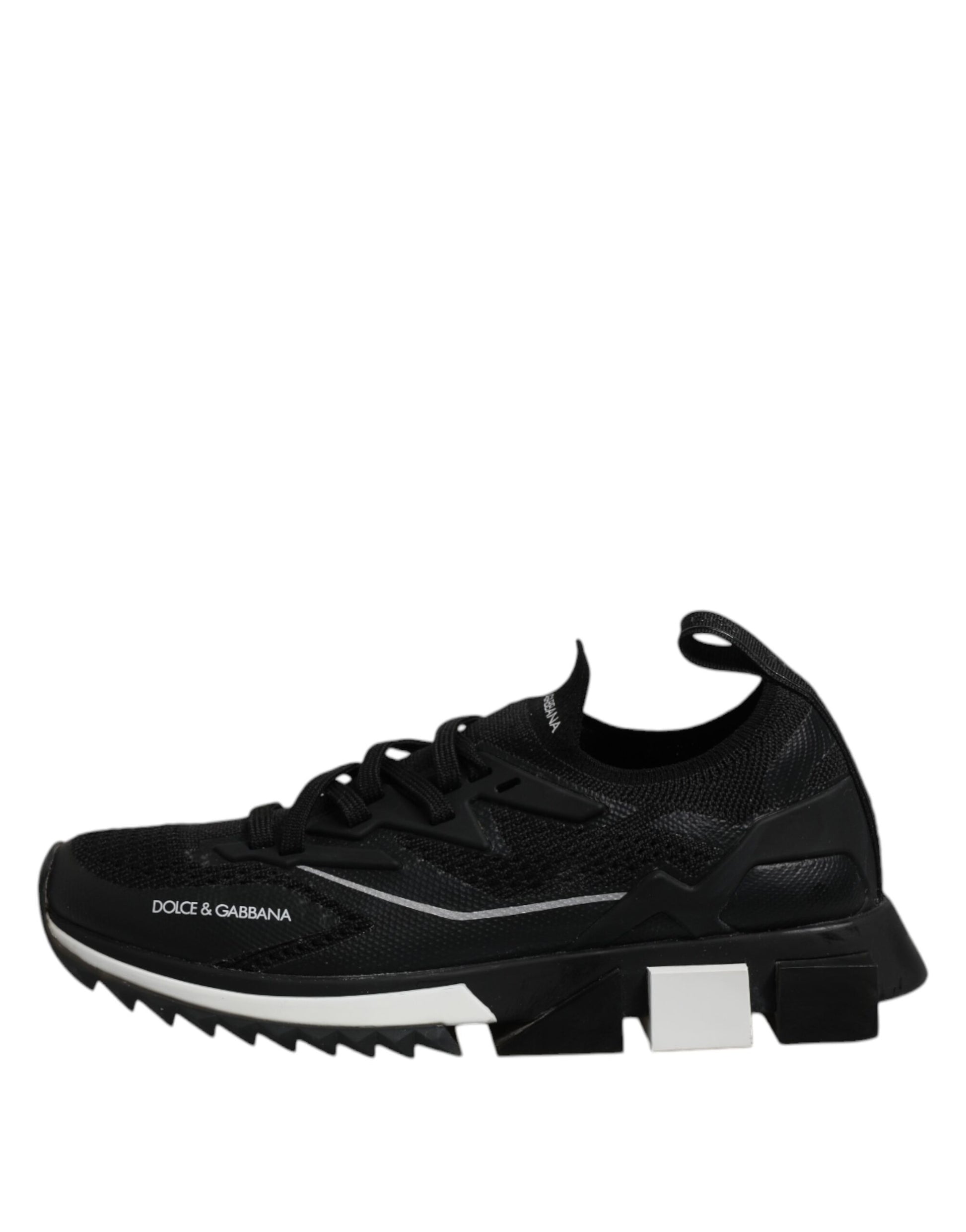 Black and white athletic shoe with cleats on bottom
