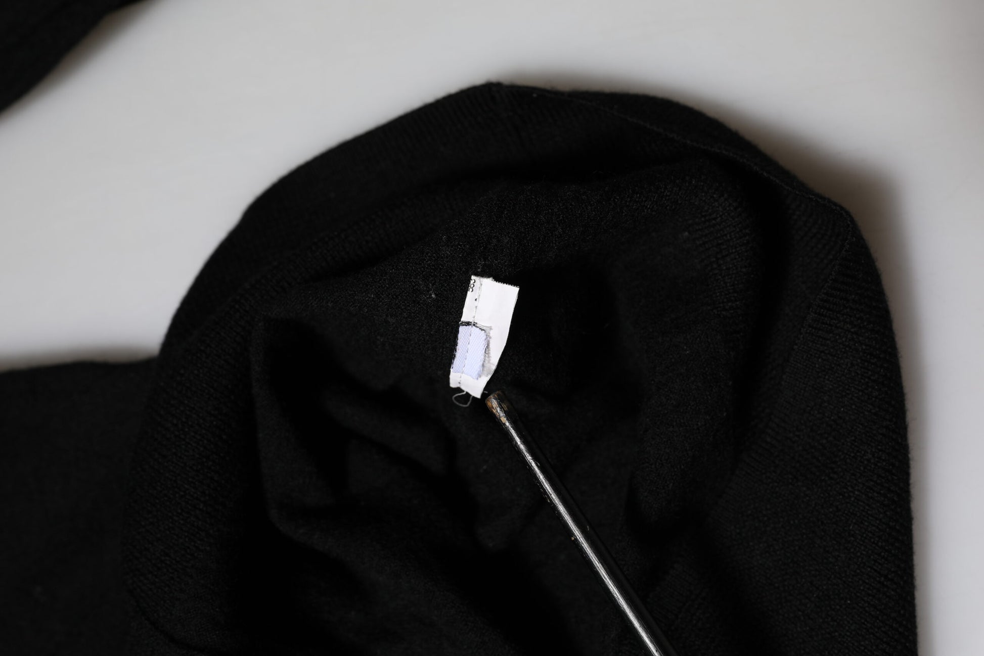Black fabric with white tag on inside