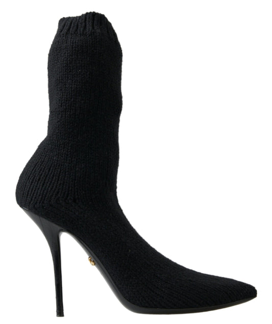 Black knee high boot with a pointed toe and a heel