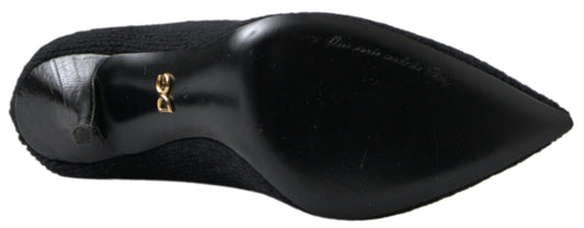 Pair of black shoes with gold buckles and laces