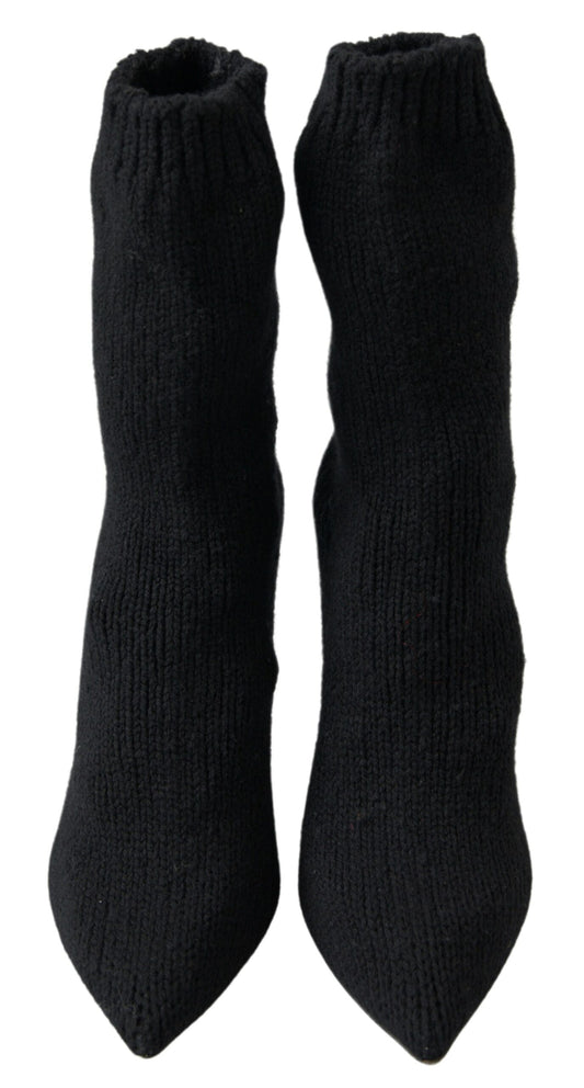 Two black socks with ribbed texture and elastic tops