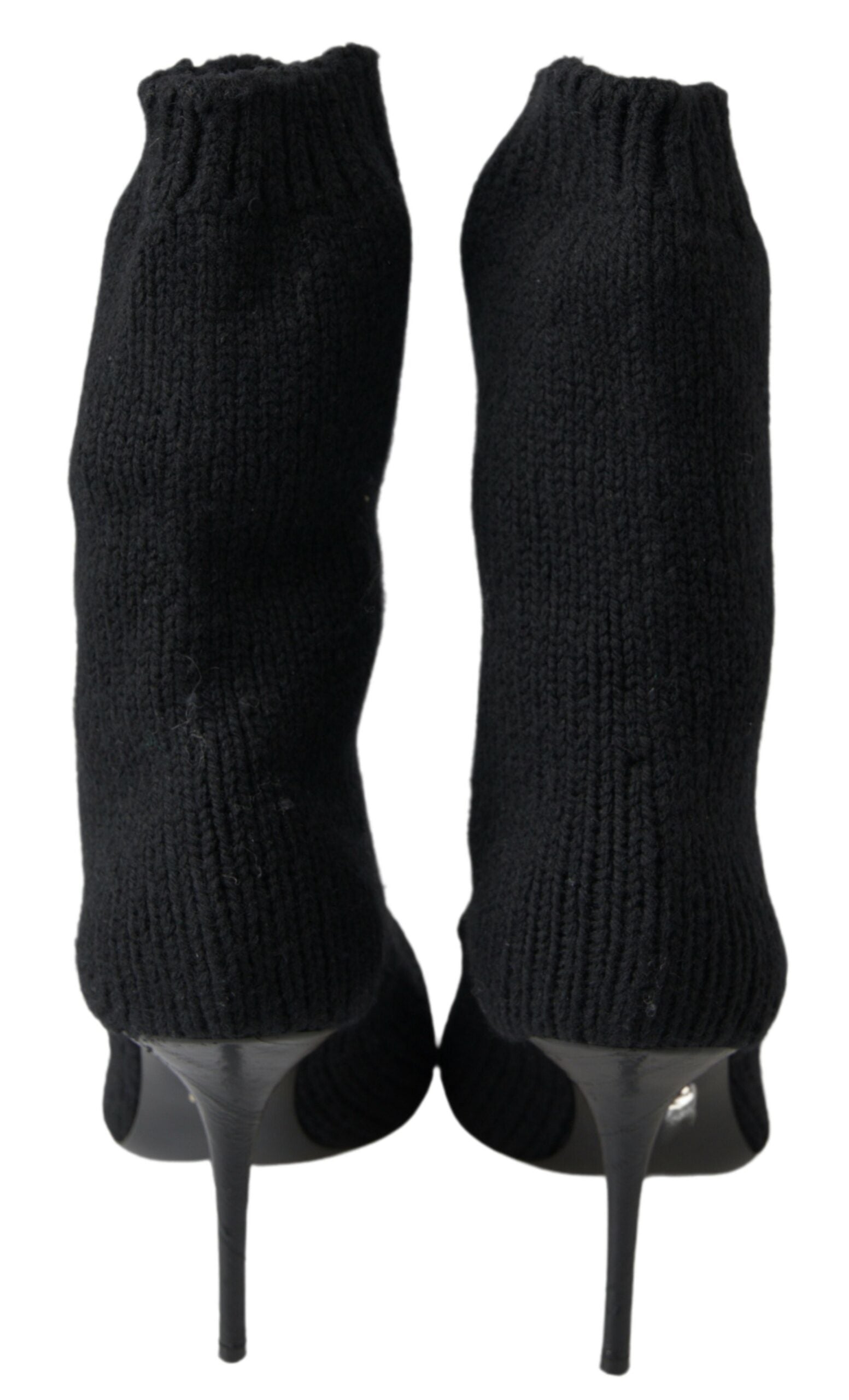 Pair of black knee high boots with heels and ribbed texture