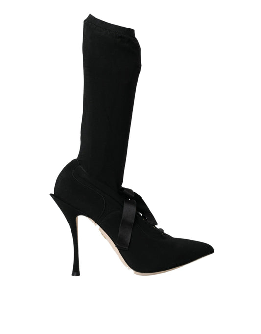 Black high heel shoe with black sock and black boot
