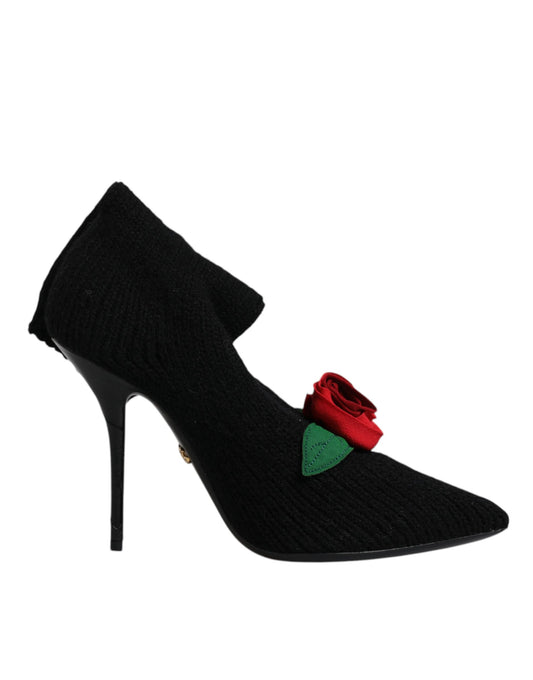 Black high heel shoe with a red bow on top