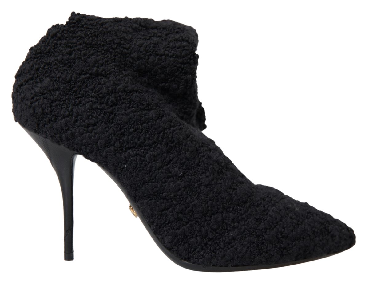 Black suede ankle boots with a pointed toe and a small heel