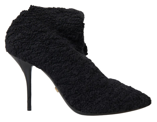 Black suede ankle boots with a pointed toe and a small heel