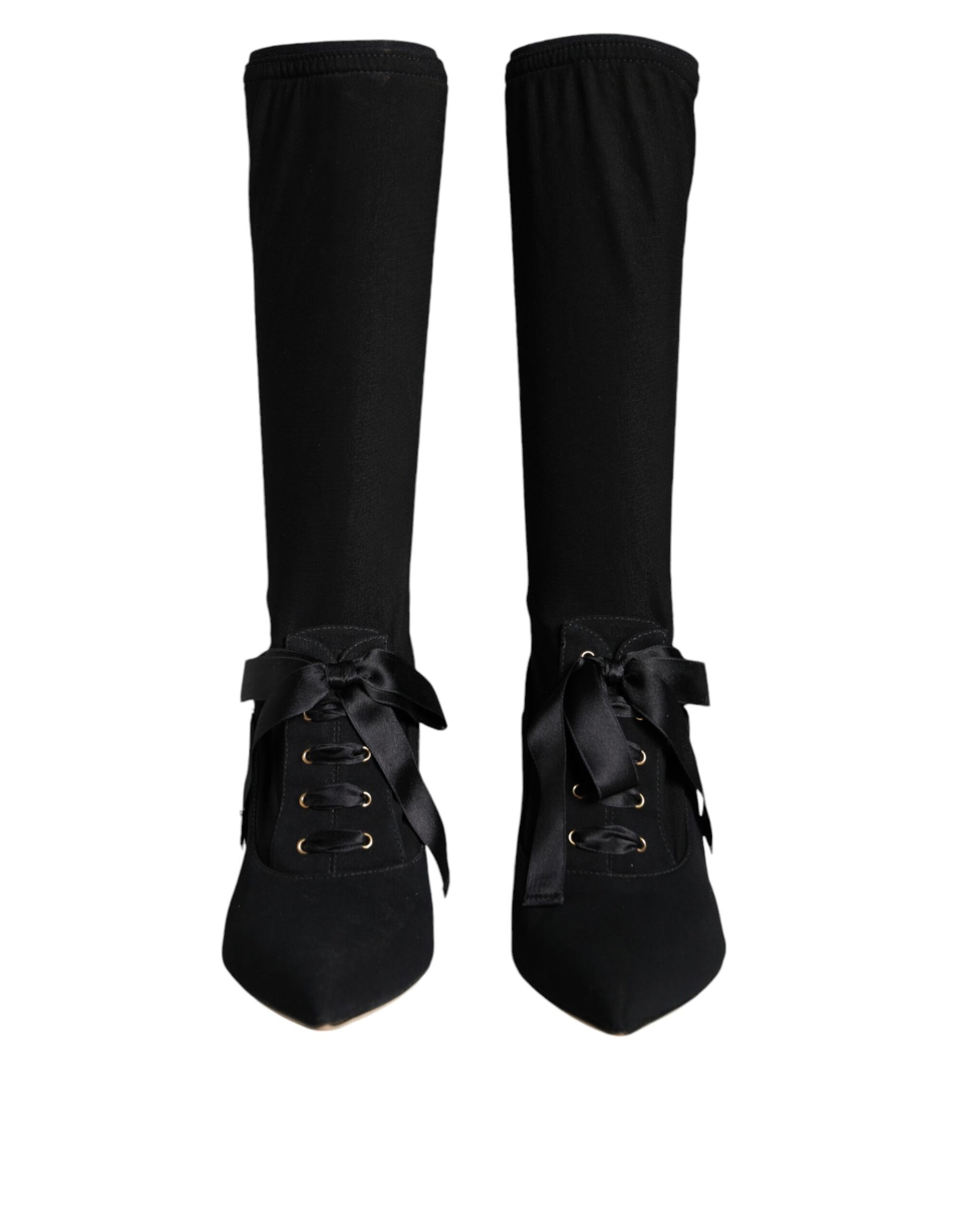 Pair of black knee high boots with laces and buckles