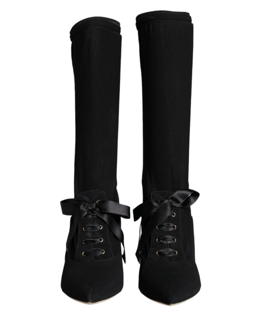 Pair of black knee high boots with laces