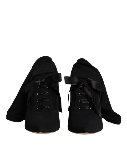 Pair of black boots with laces and buckles