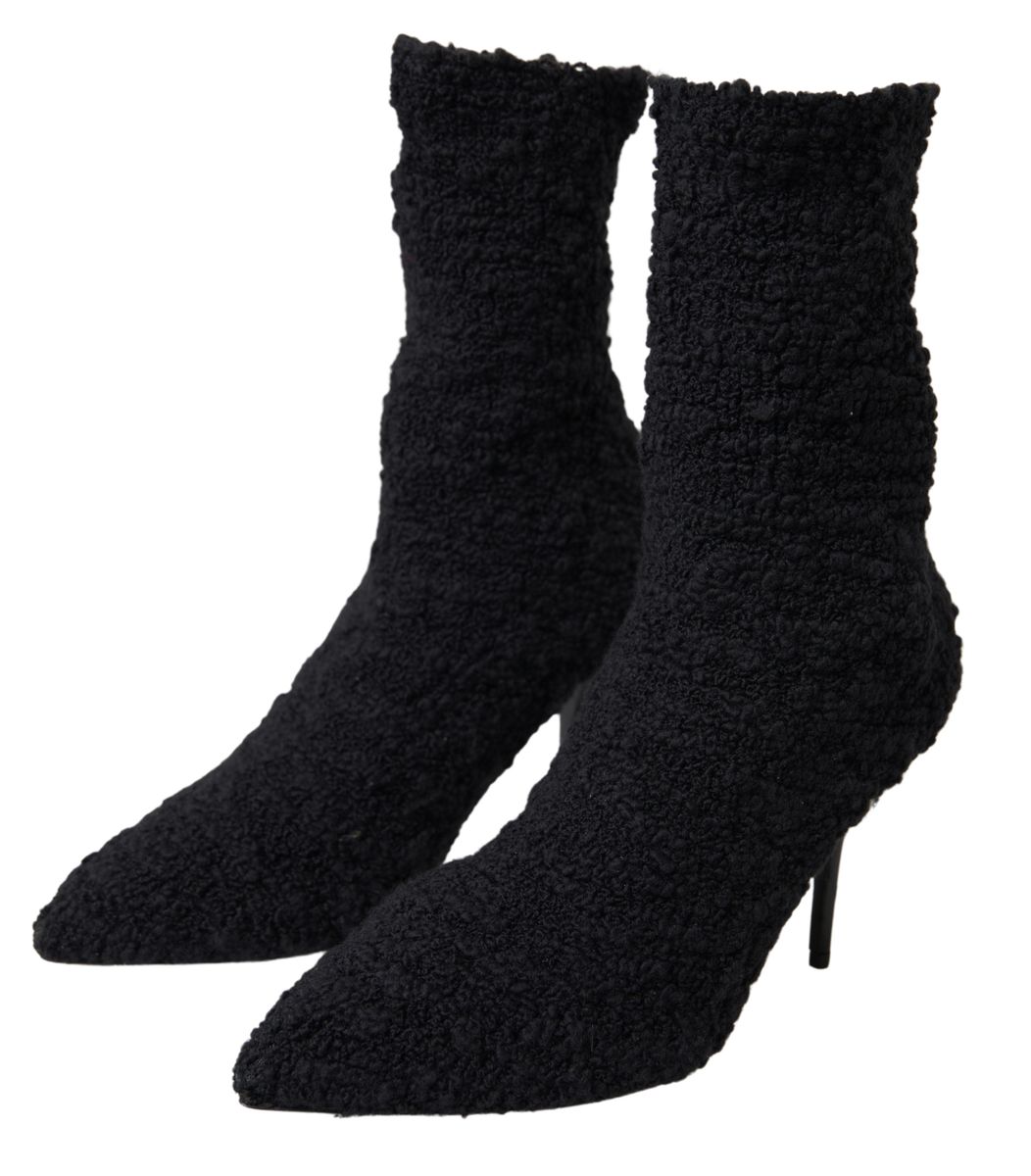 Pair of black furry boots with high heels