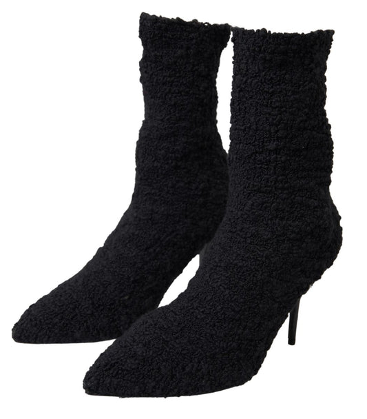 Pair of black furry boots with high heels