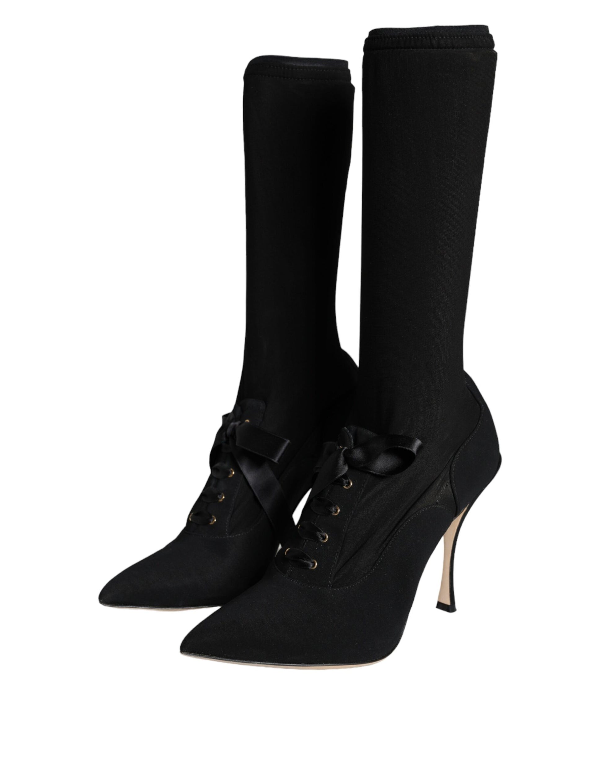 Pair of black knee high boots with buckles and heels