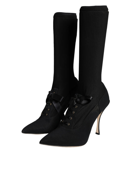 Pair of black knee high boots with buckles and heels