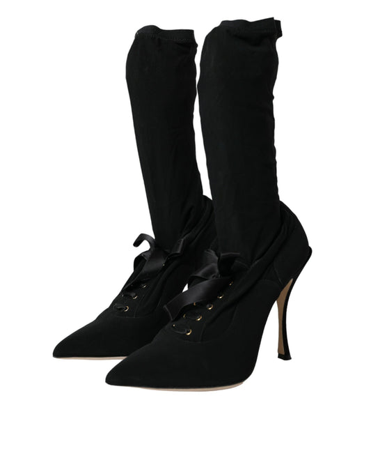 Pair of black knee high boots with laces and heels