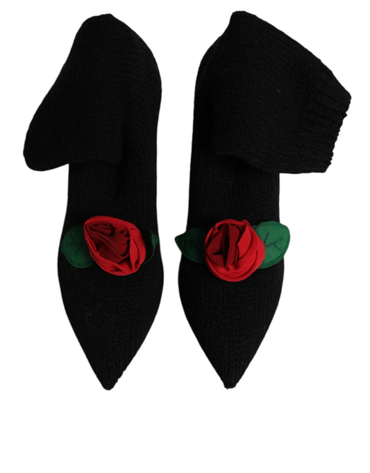 Pair of black shoes with red rose embellishments on top