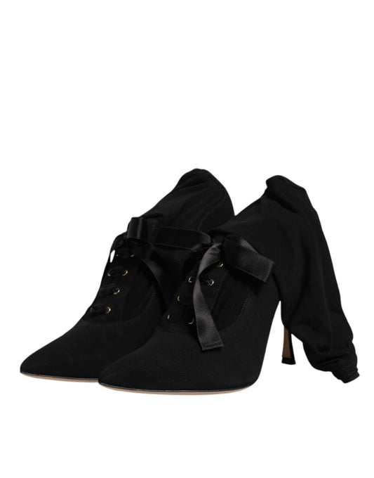 Pair of black suede ankle boots with gold buckles