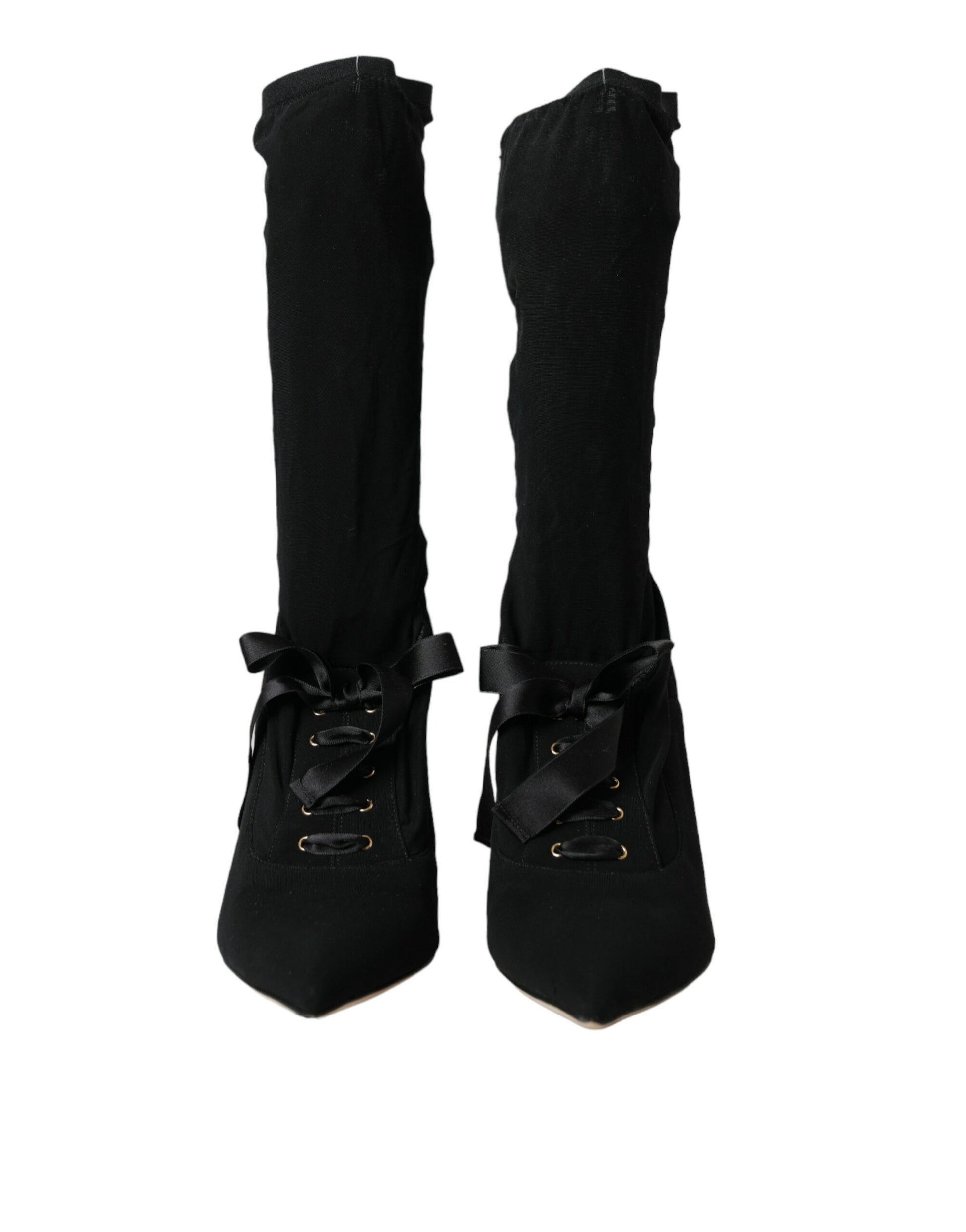 Pair of black knee high boots with laces and buckles