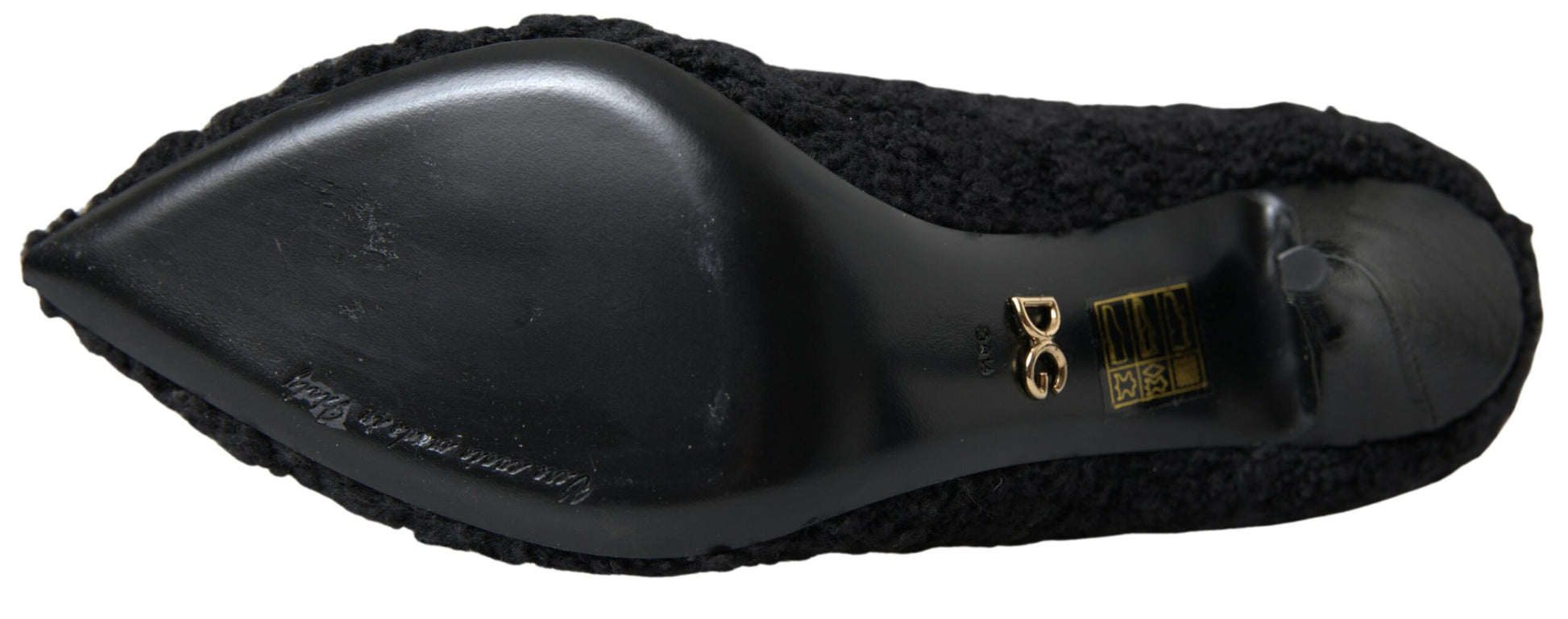 Black high heel shoe with gold buckle and strap