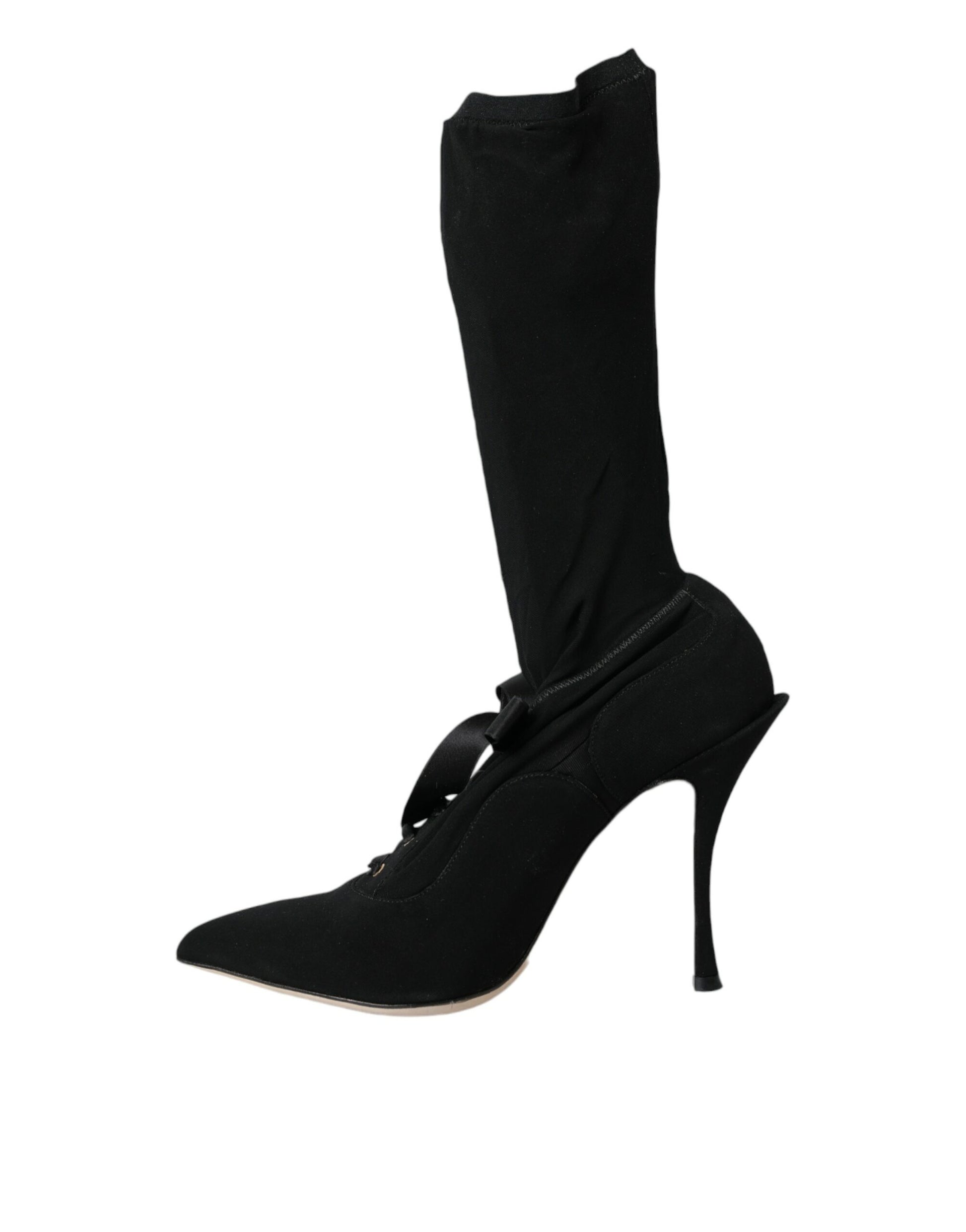 Black high heel shoe with black laces and a black strap over the top of the foot