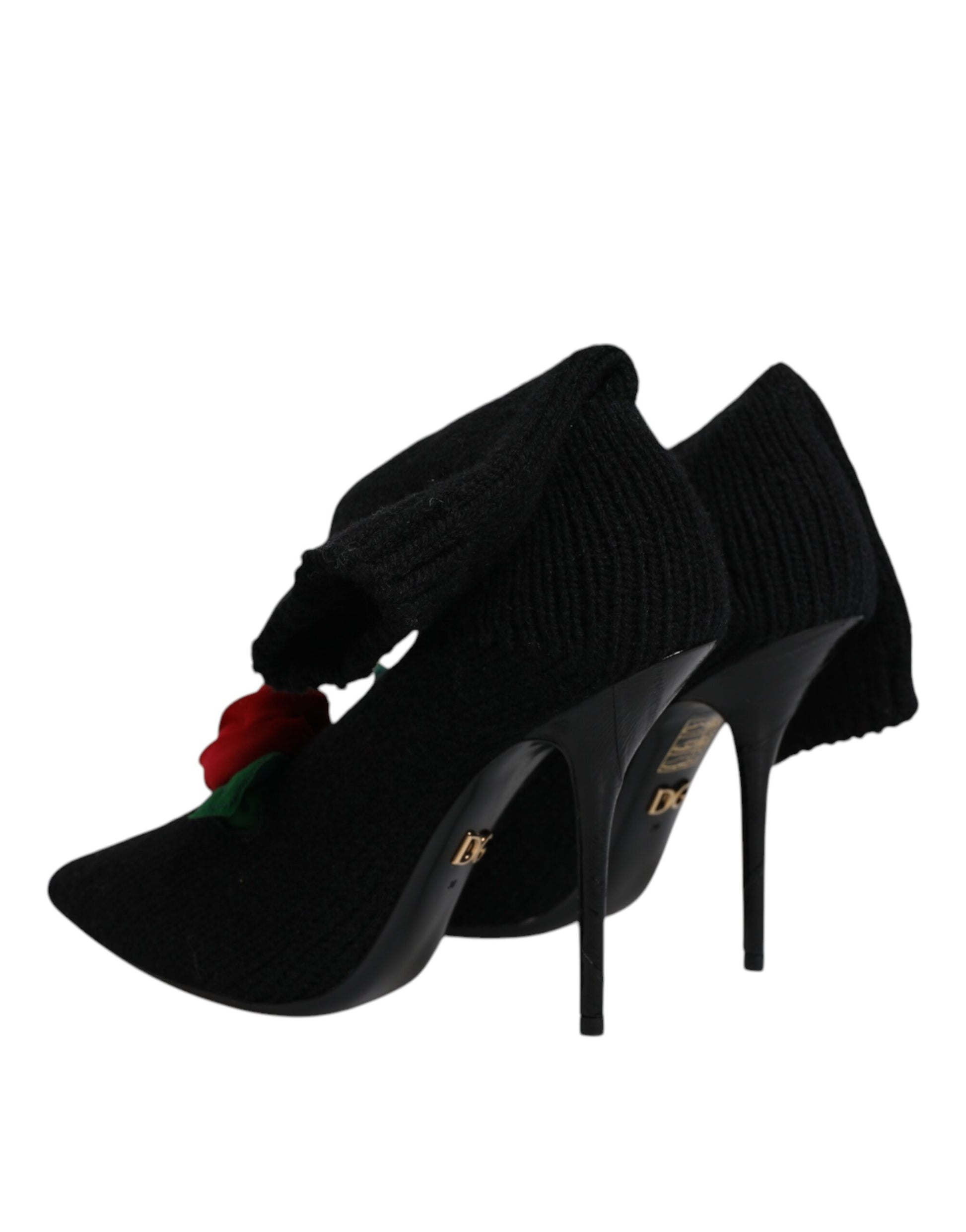 Pair of black high heel shoes with red flower embellishment
