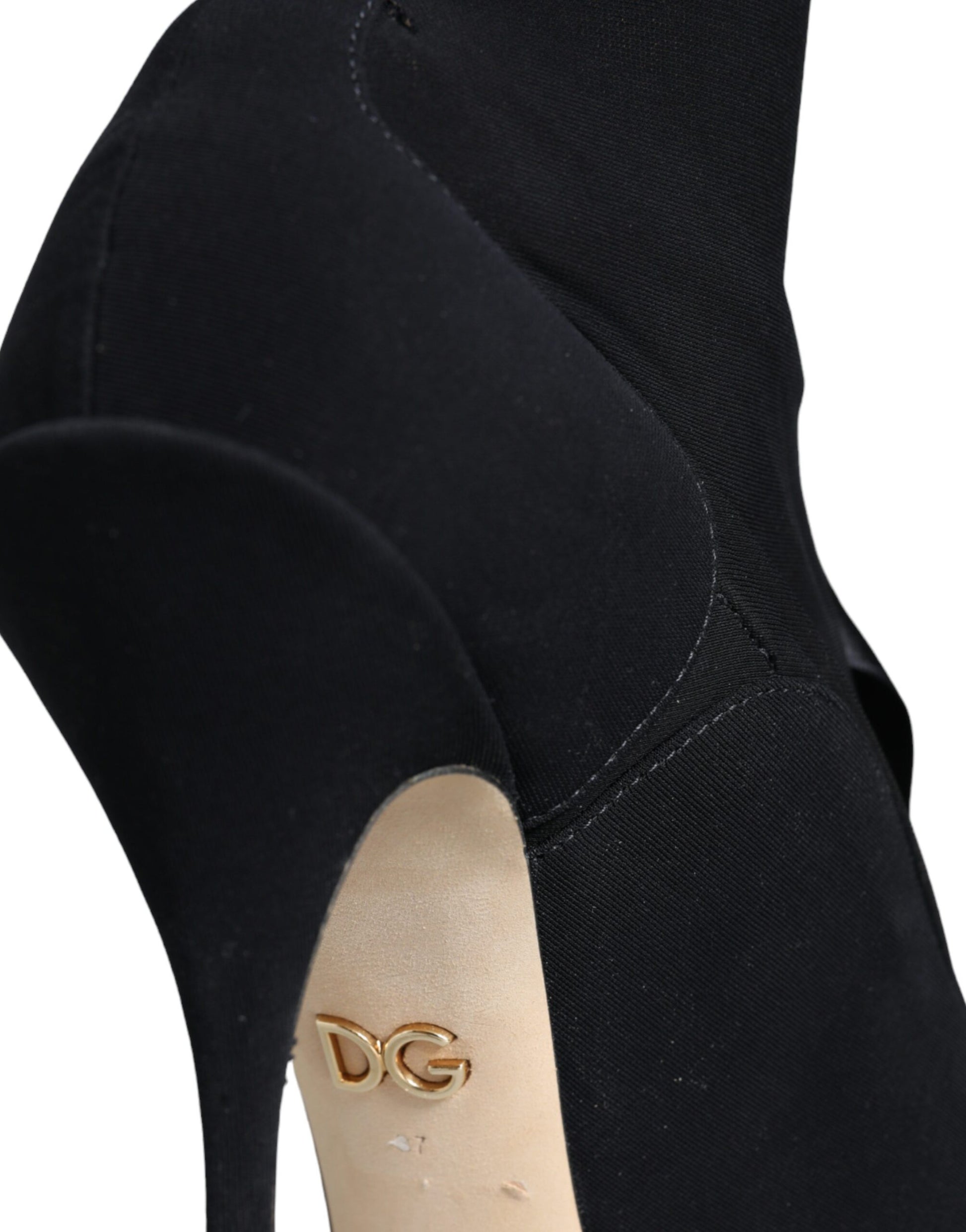 Black high heel shoe with gold logo on insole