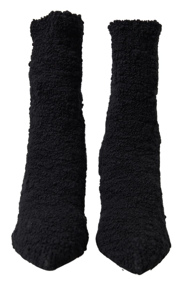 Two black socks with ribbed texture and cuffs