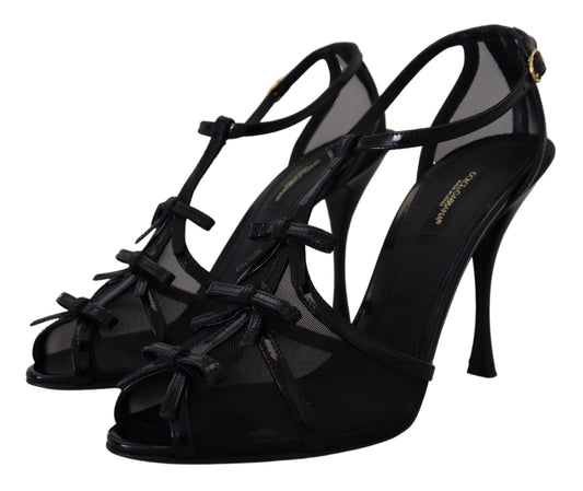 Pair of black high heel shoes with straps and bow detailing