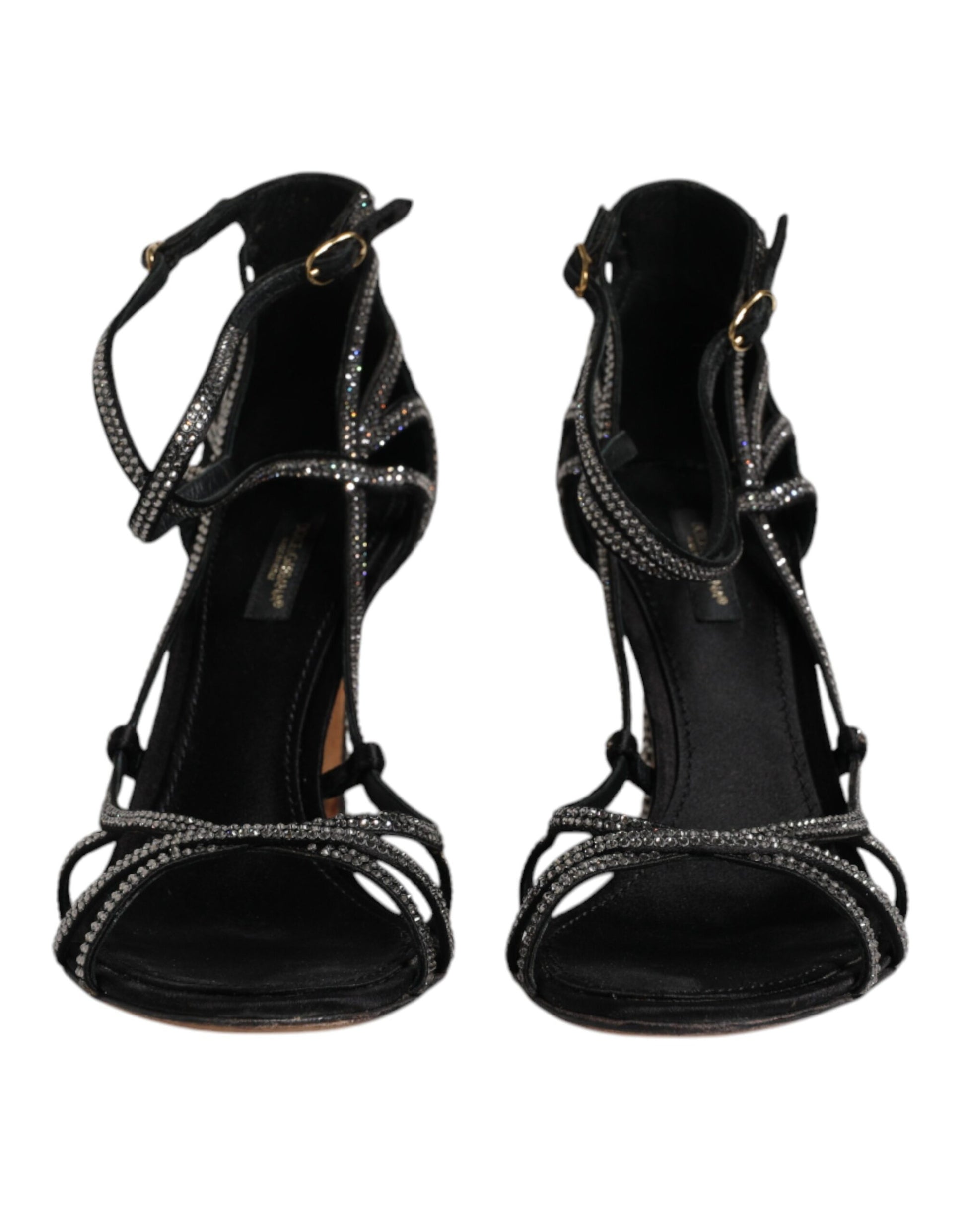 Pair of black high heel shoes with straps and embellishments