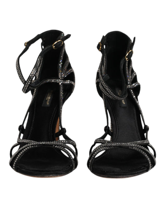Pair of black high heel shoes with straps and embellishments