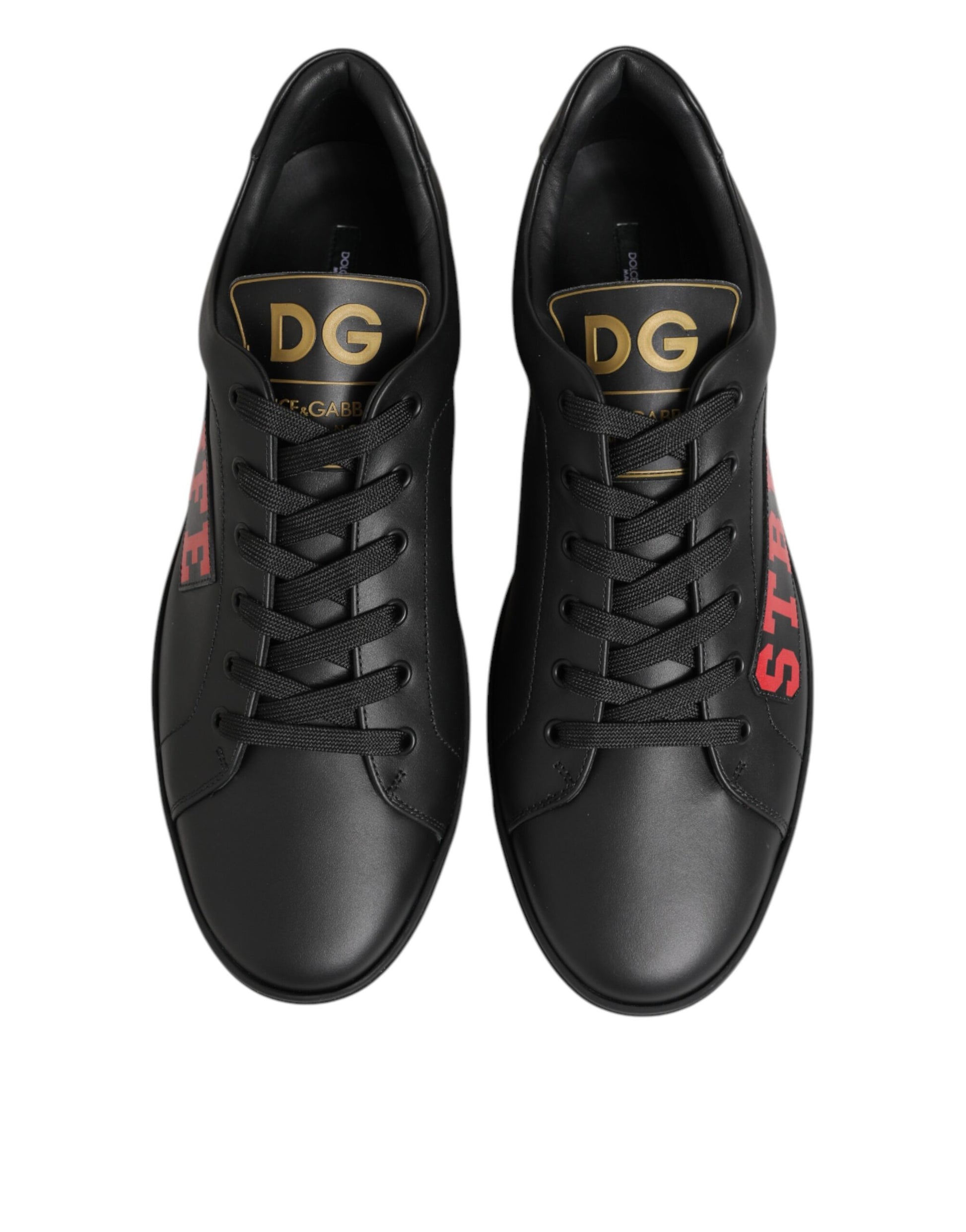 Pair of black sneakers with gold lettering on side