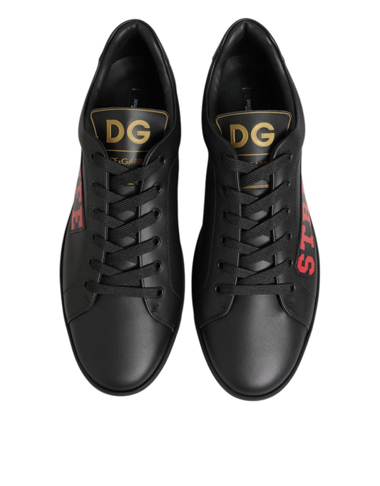 Pair of black sneakers with gold lettering on side