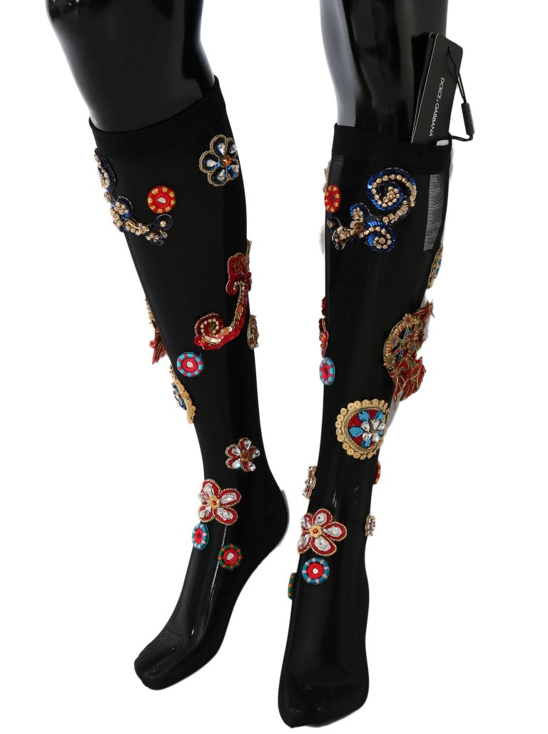 Black knee high boots with floral embroidery on legs