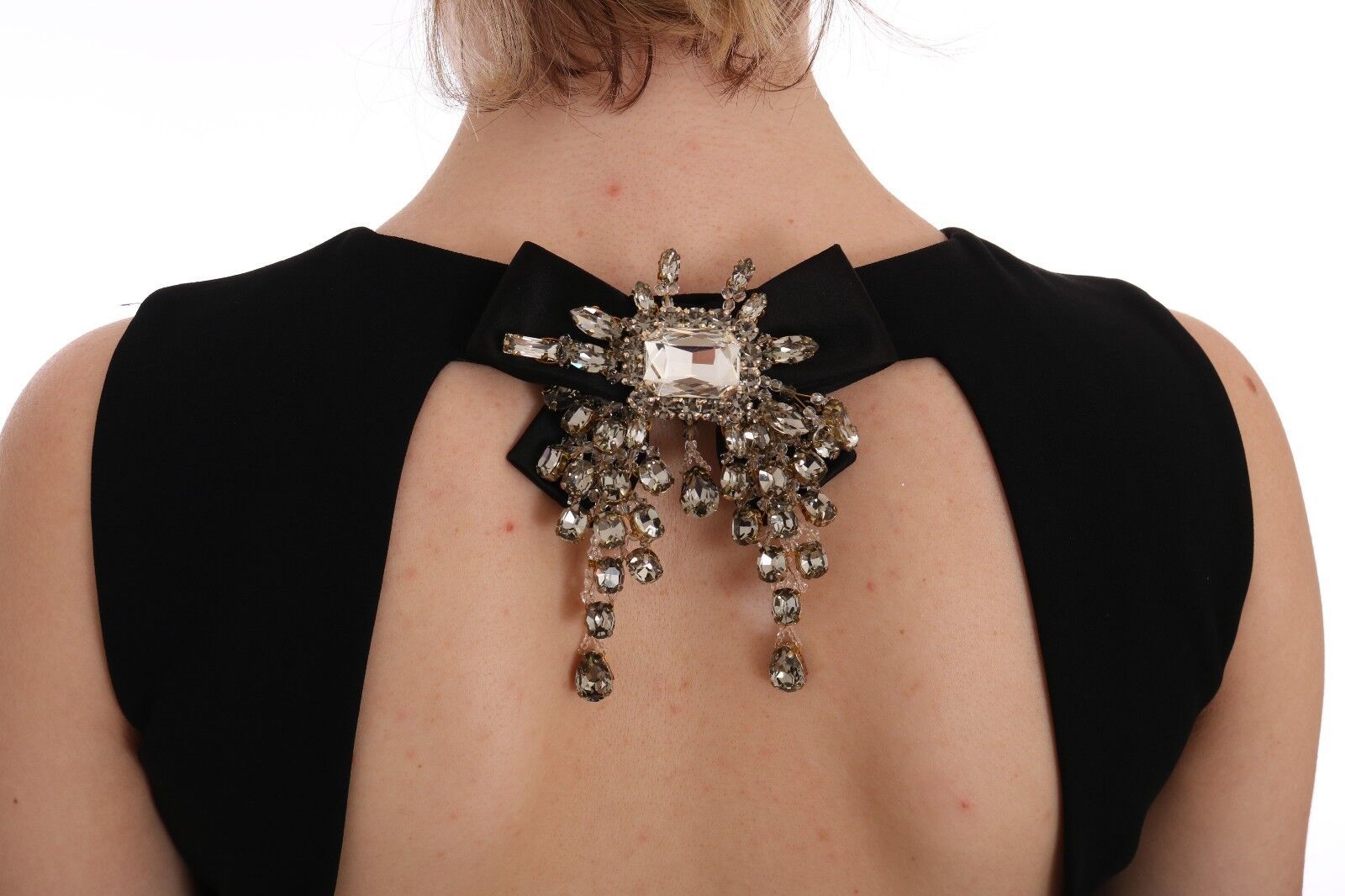 A black dress with a crystal bow on the back