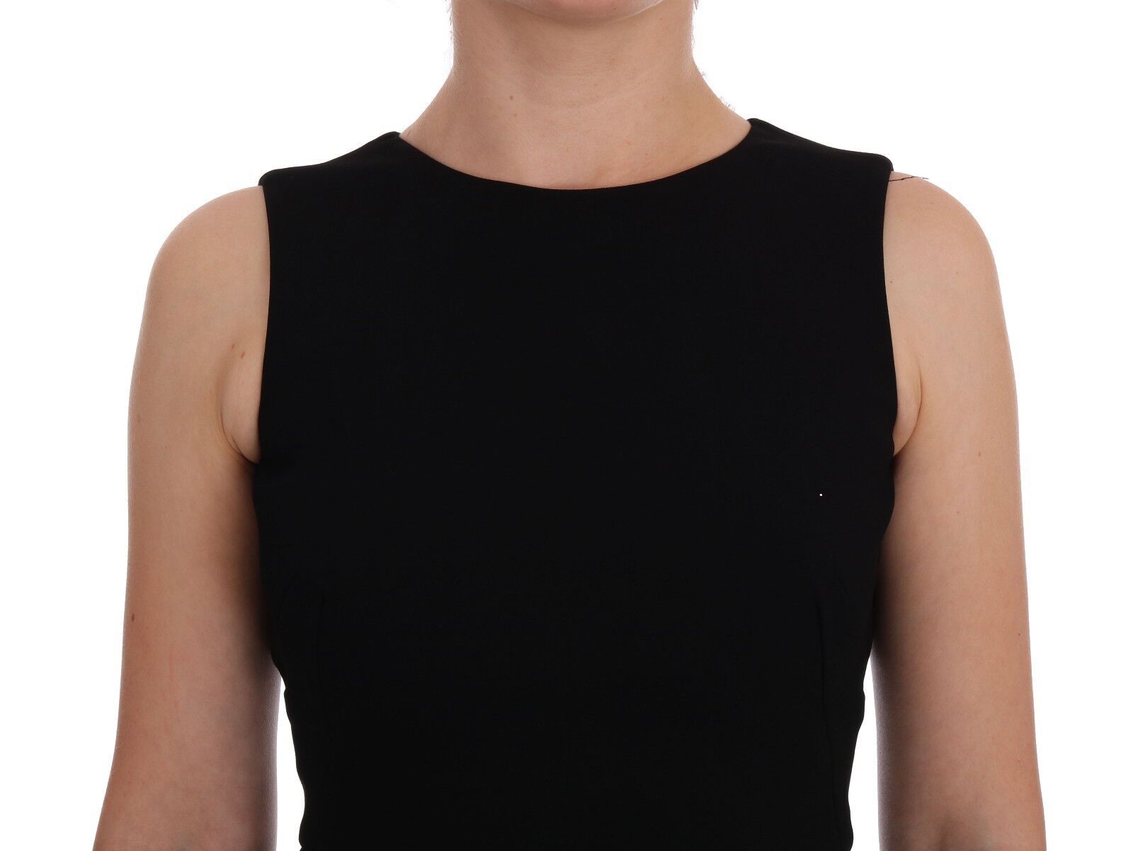 A black dress with a sheer overlay and crystal embellishments. It is designed by Dolce & Gabbana, and it appe