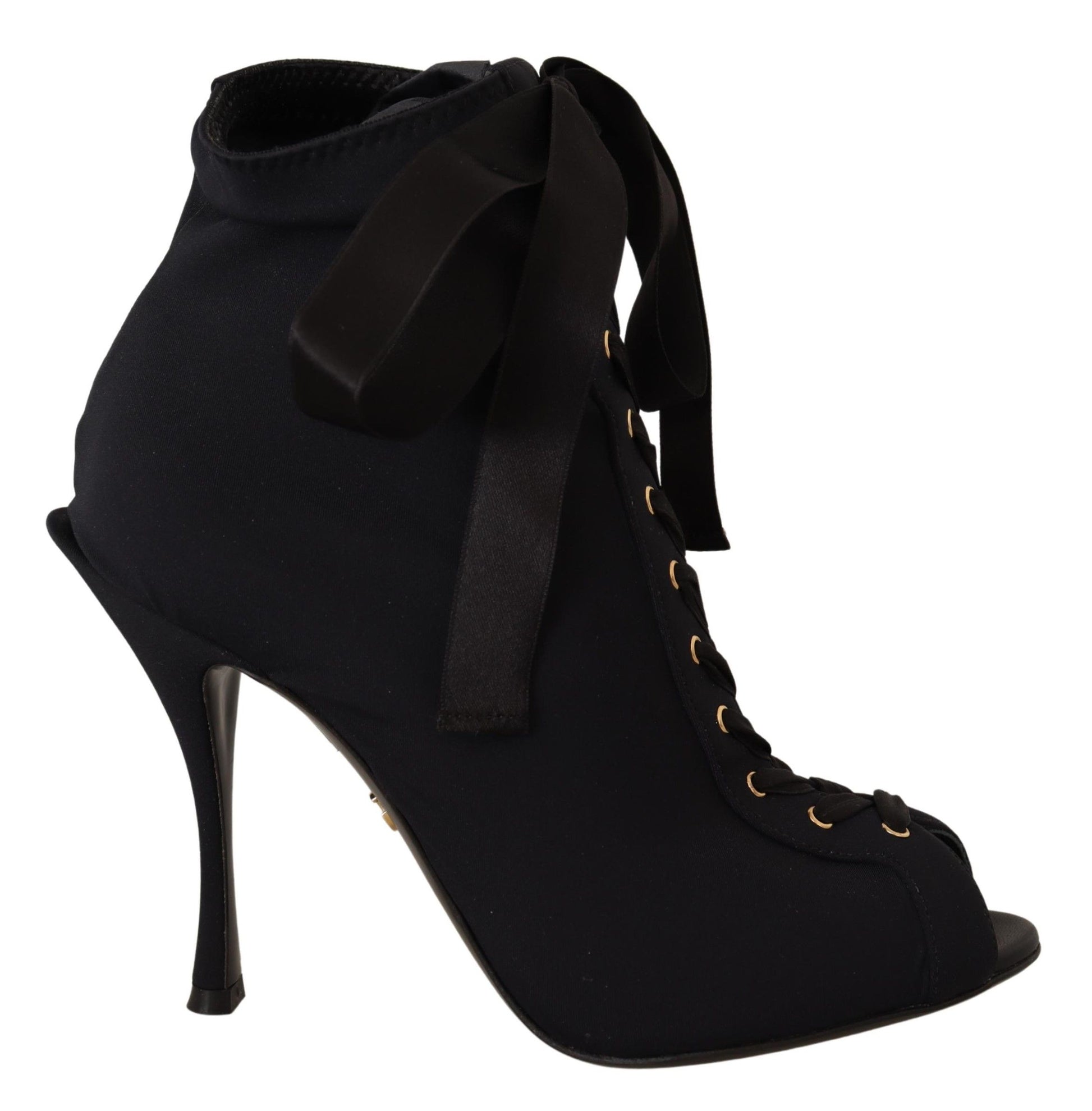 Black ankle boot with gold buckles and black bow