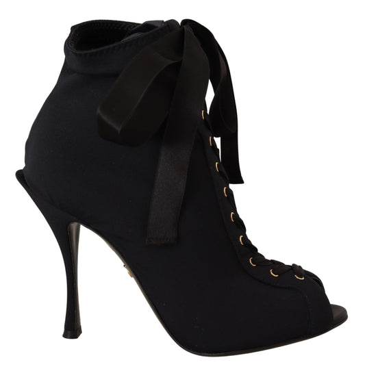 Black ankle boot with gold buckles and black bow