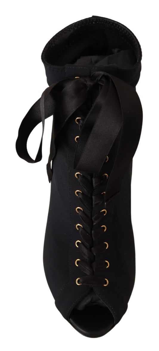 Black boot with gold buttons and a bow on top