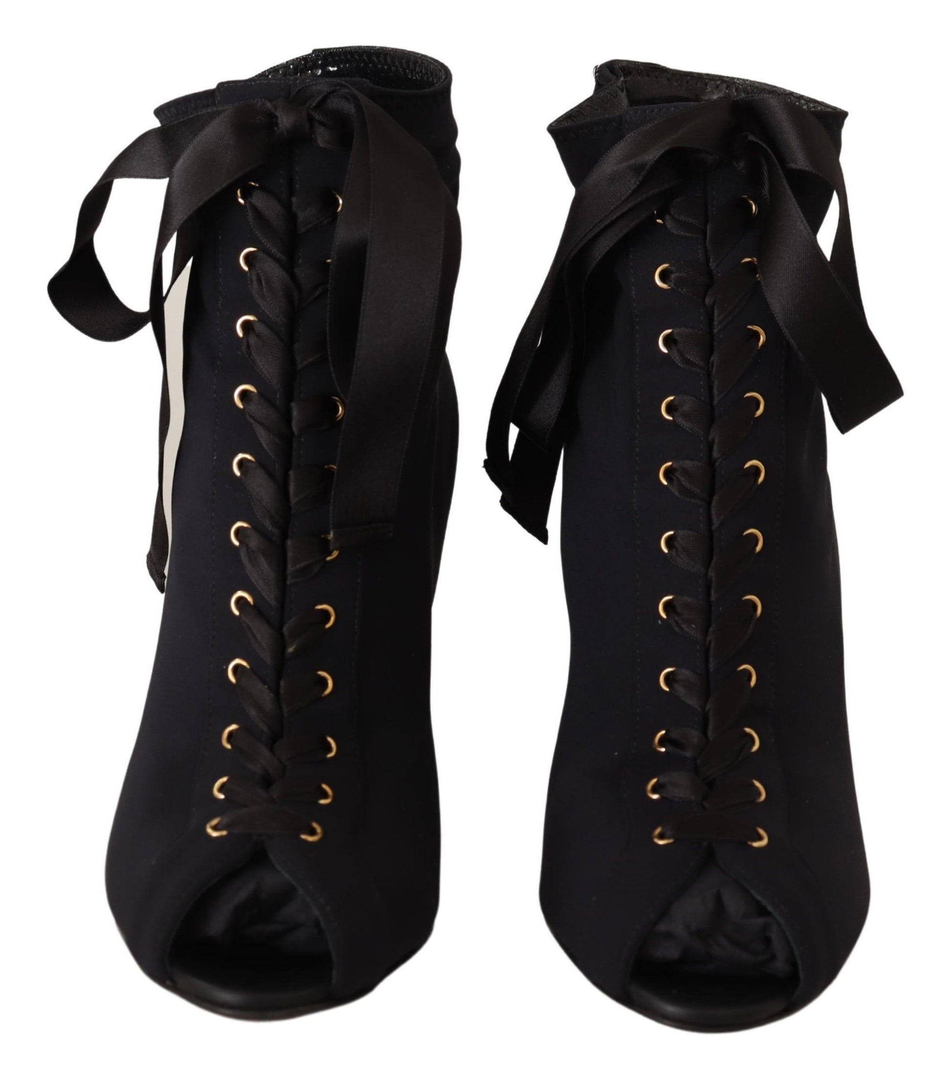 Pair of black boots with gold buckles and laces