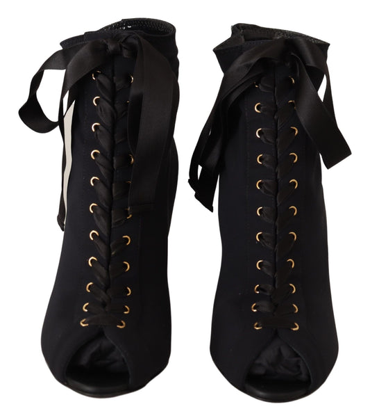 Pair of black boots with gold buckles and laces