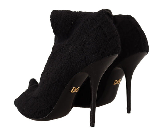 Pair of black high heel shoes with fur trim and gold lettering on soles