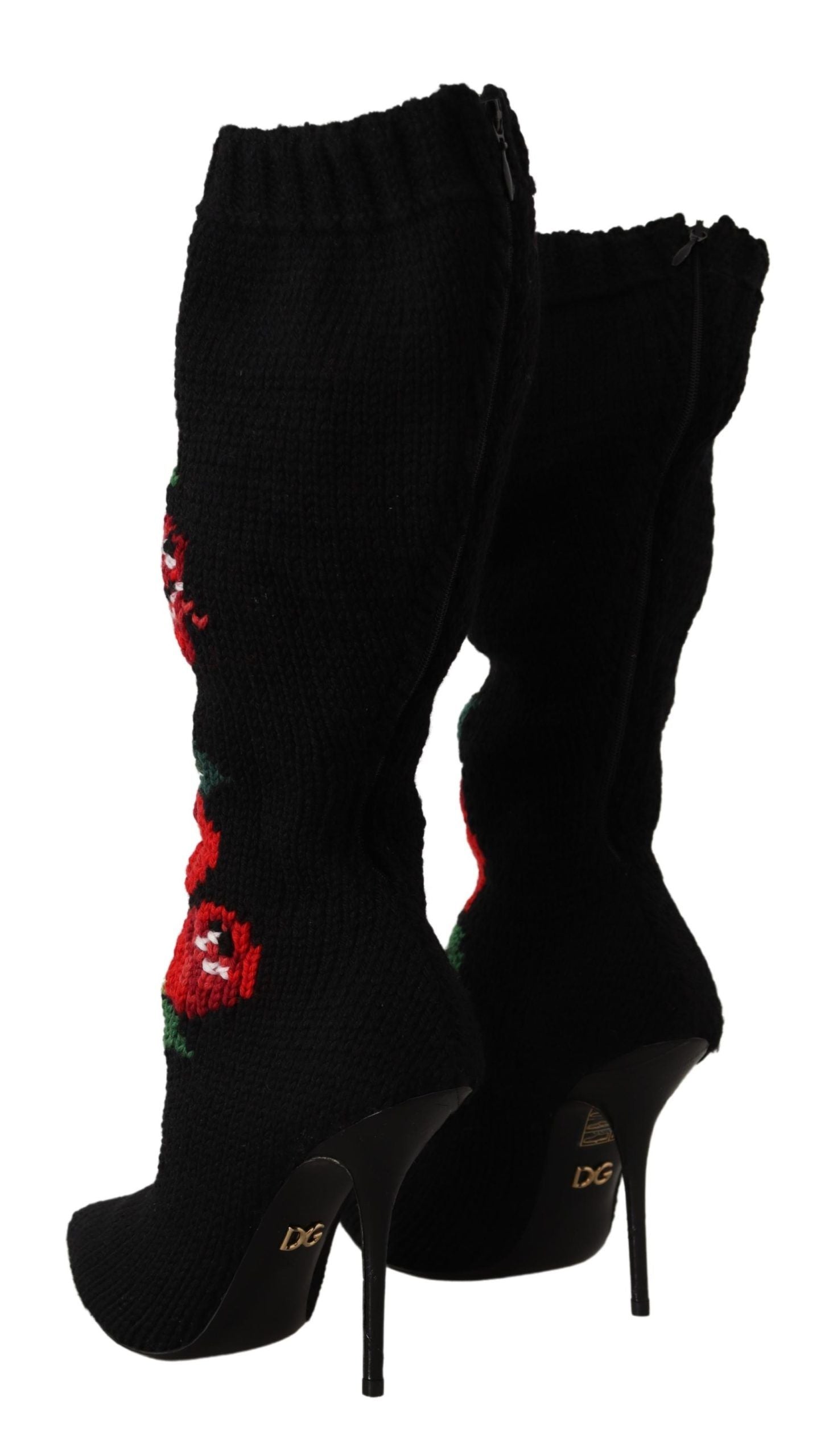 Pair of black knee high boots with red floral pattern and gold buckles