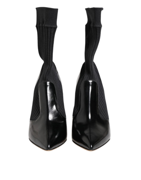 Pair of black knee high boots with elastic at top