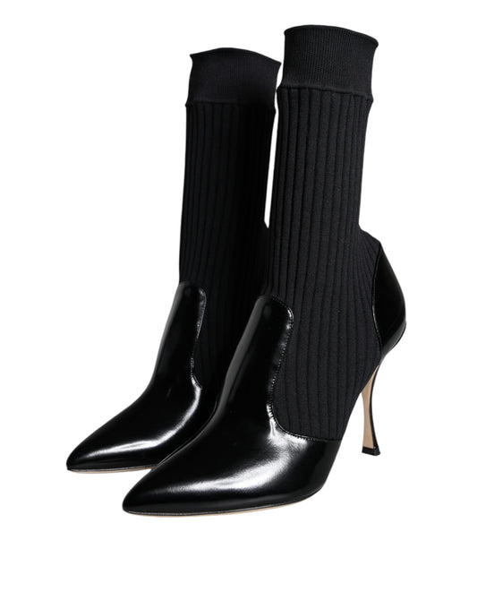 Pair of black knee high boots with a decorative stitch pattern on top