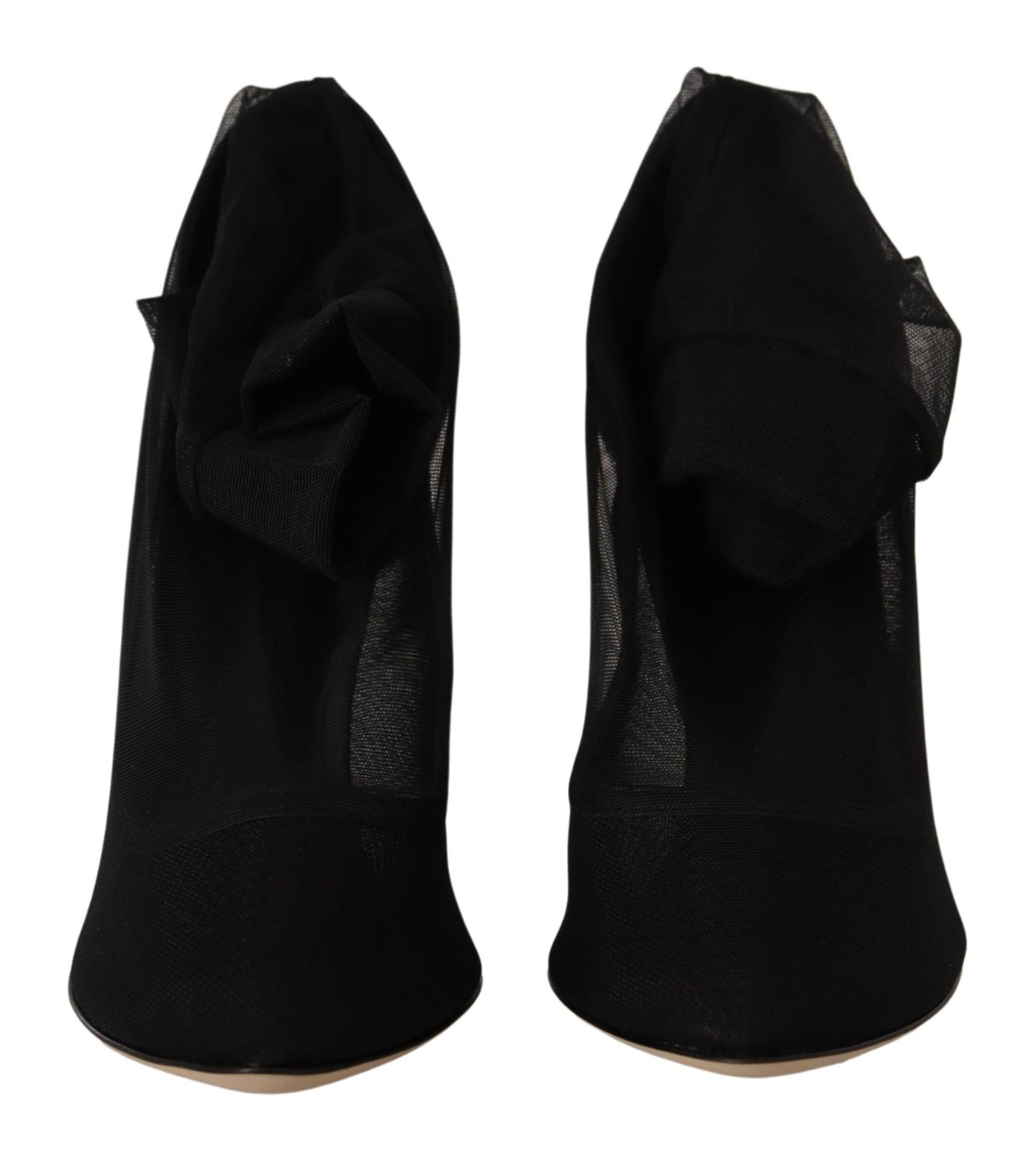 Pair of black high heel shoes with ruffled straps and a bow on top
