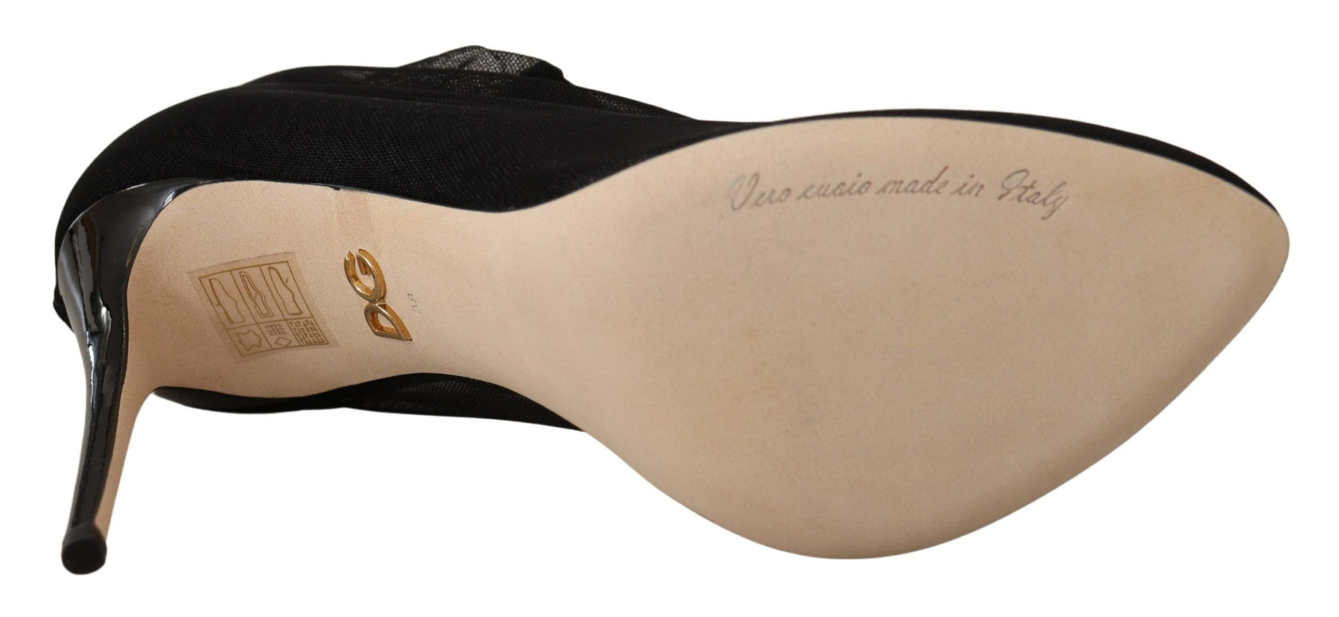 Black high heel shoe with tan toe and heel