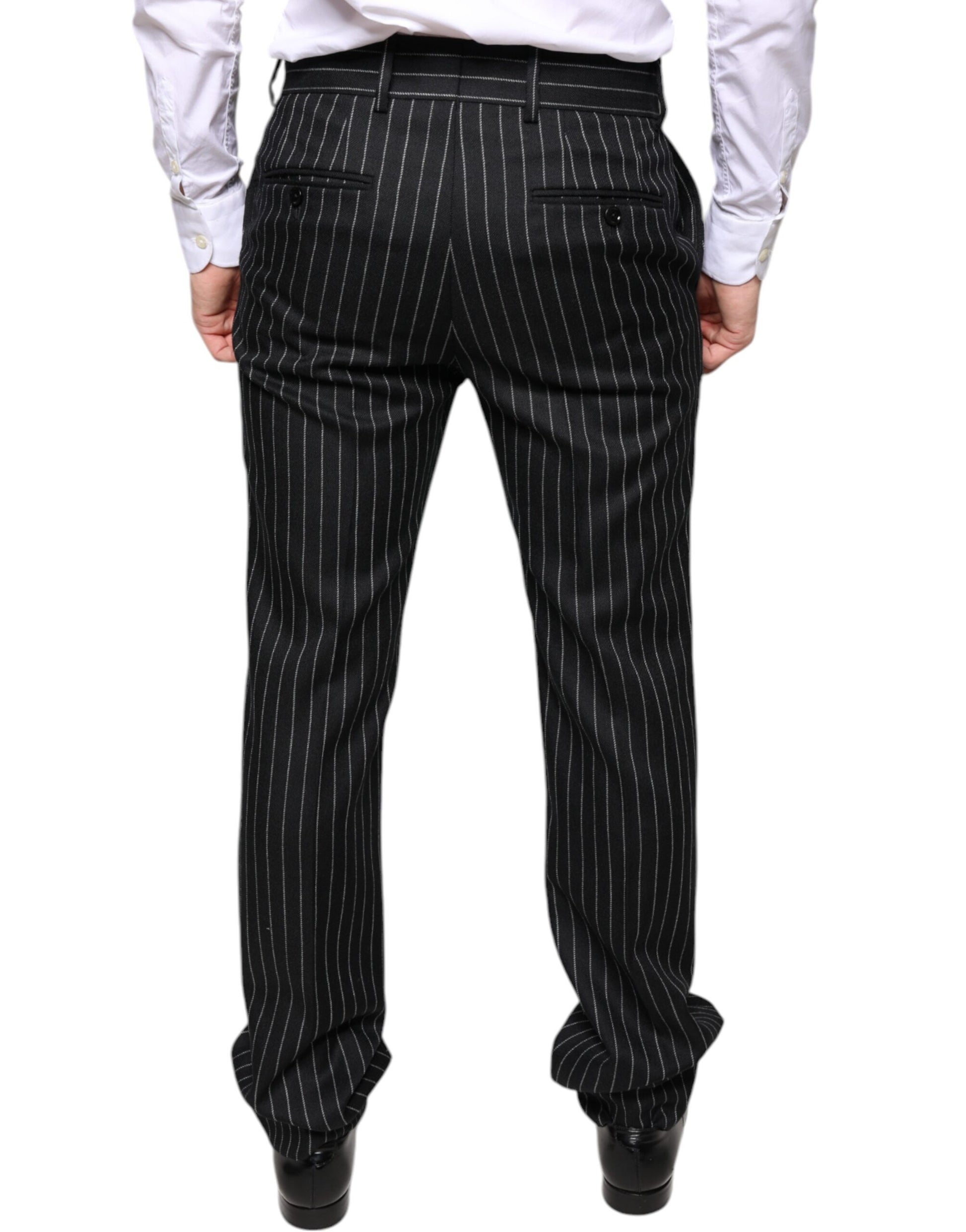 A pair of black pants with thin vertical stripes, designed by Dolce & Gabbana. They are intended for men and